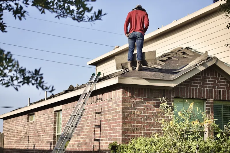 Professional roofer working on a residential roof in Woodcrest